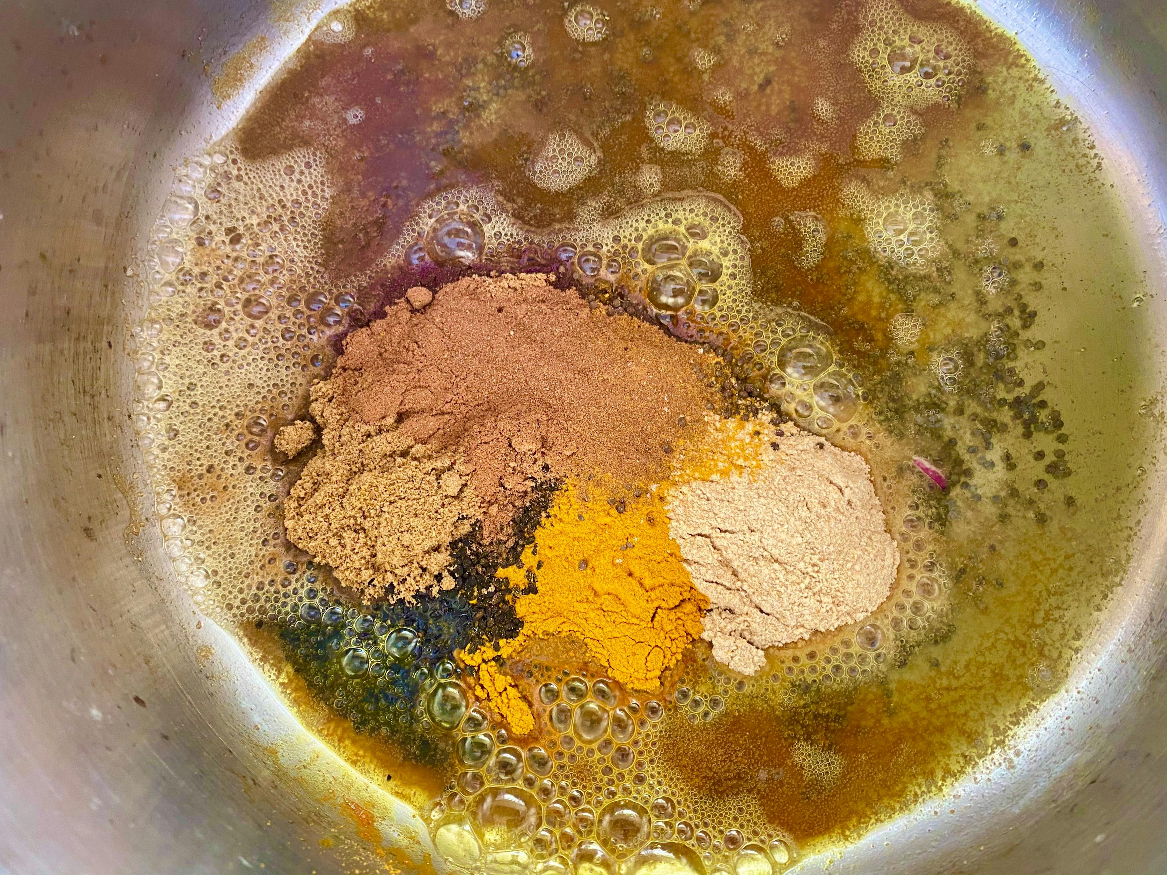spices frying in sauce pan