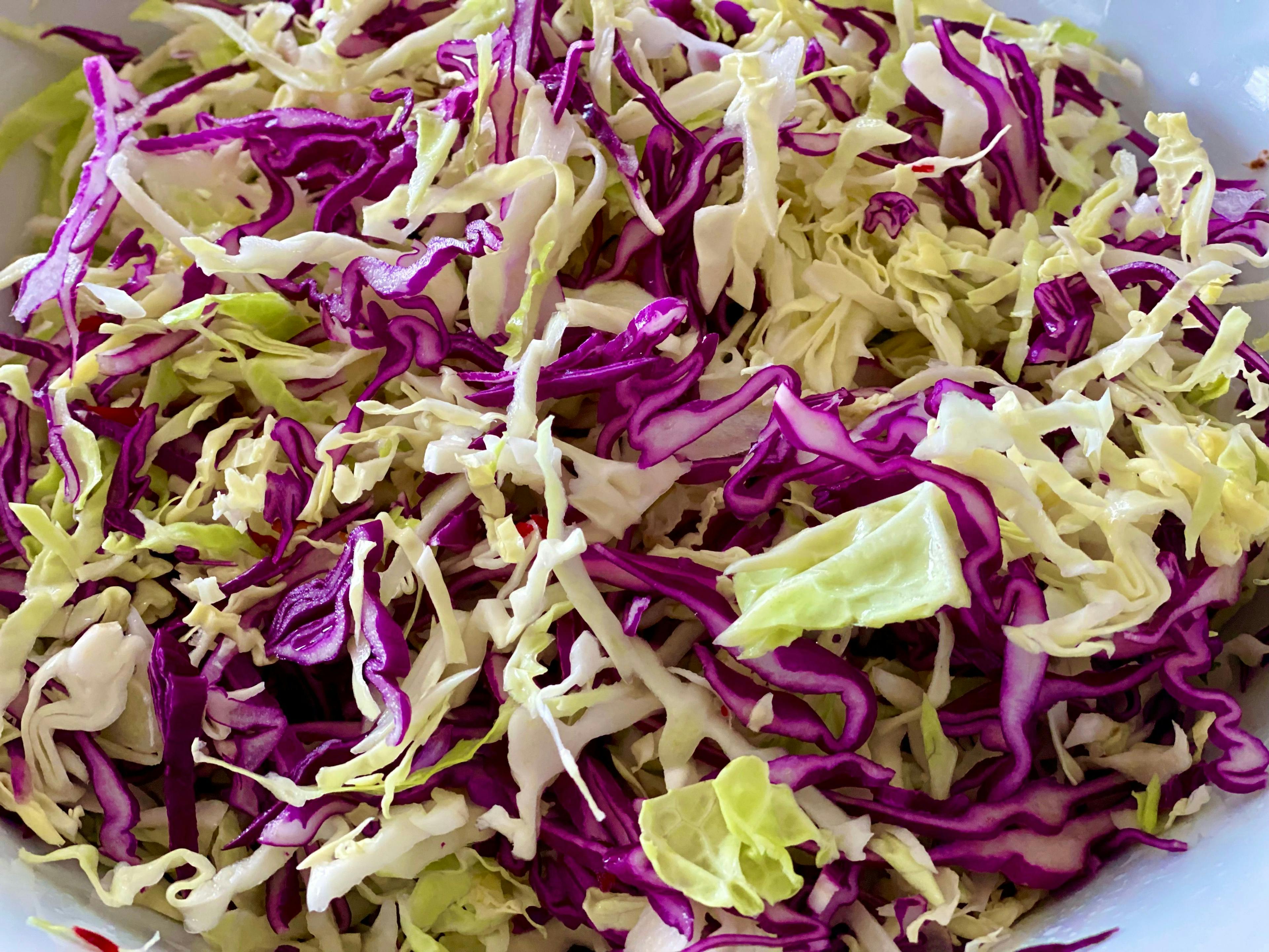 shredded white and red cabbage in a bowl