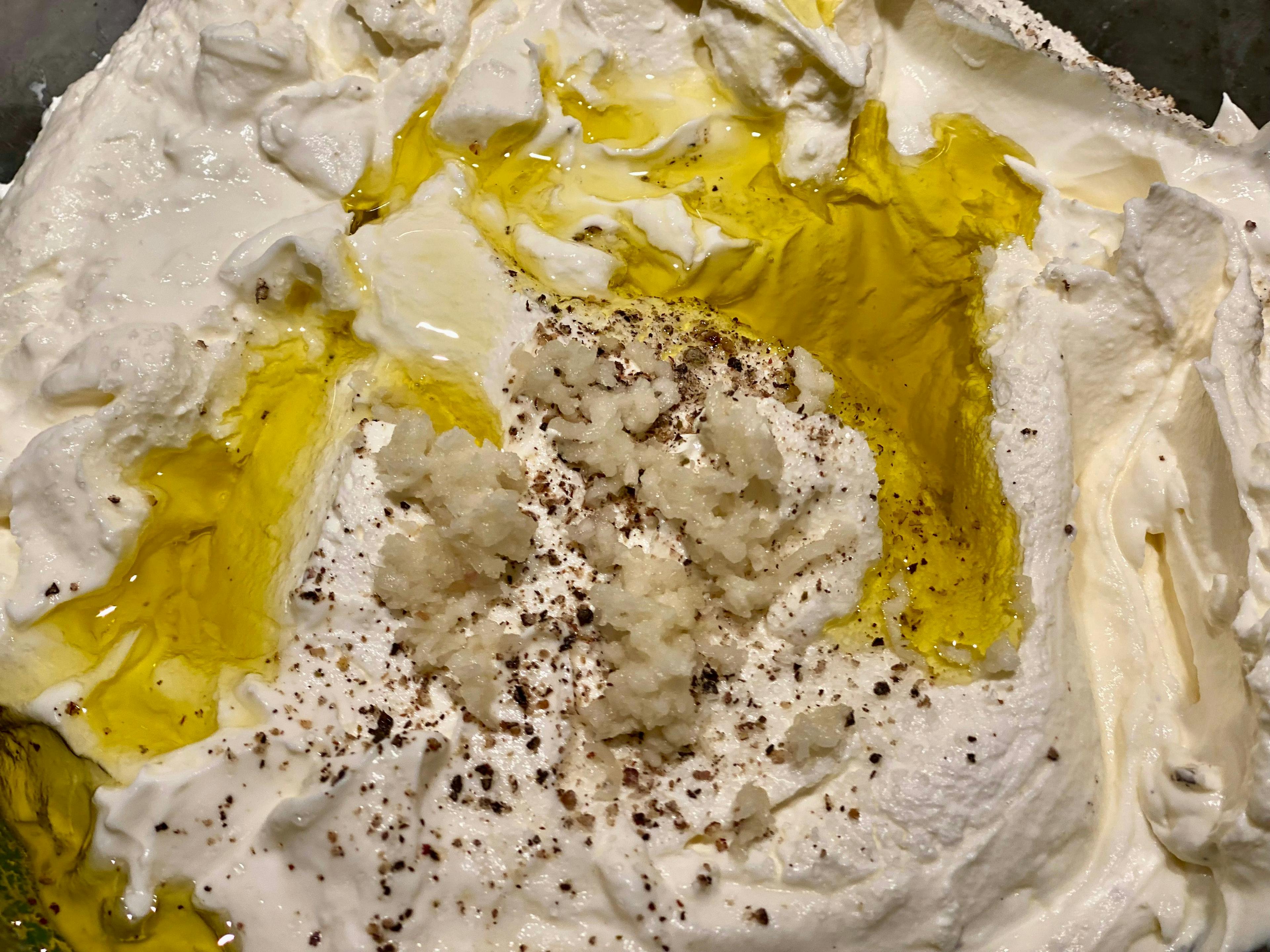 strained yogurt with garlic, oil, salt and pepper