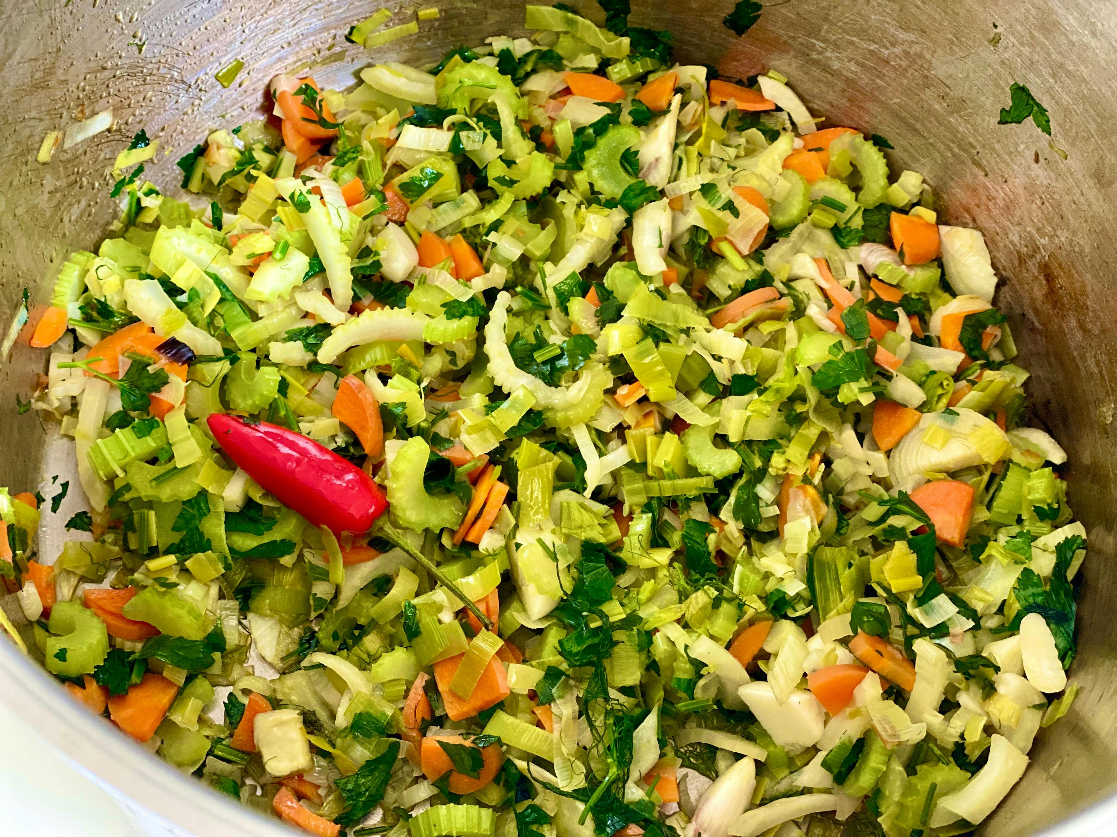 chopped vegetables and chilli in saucepan