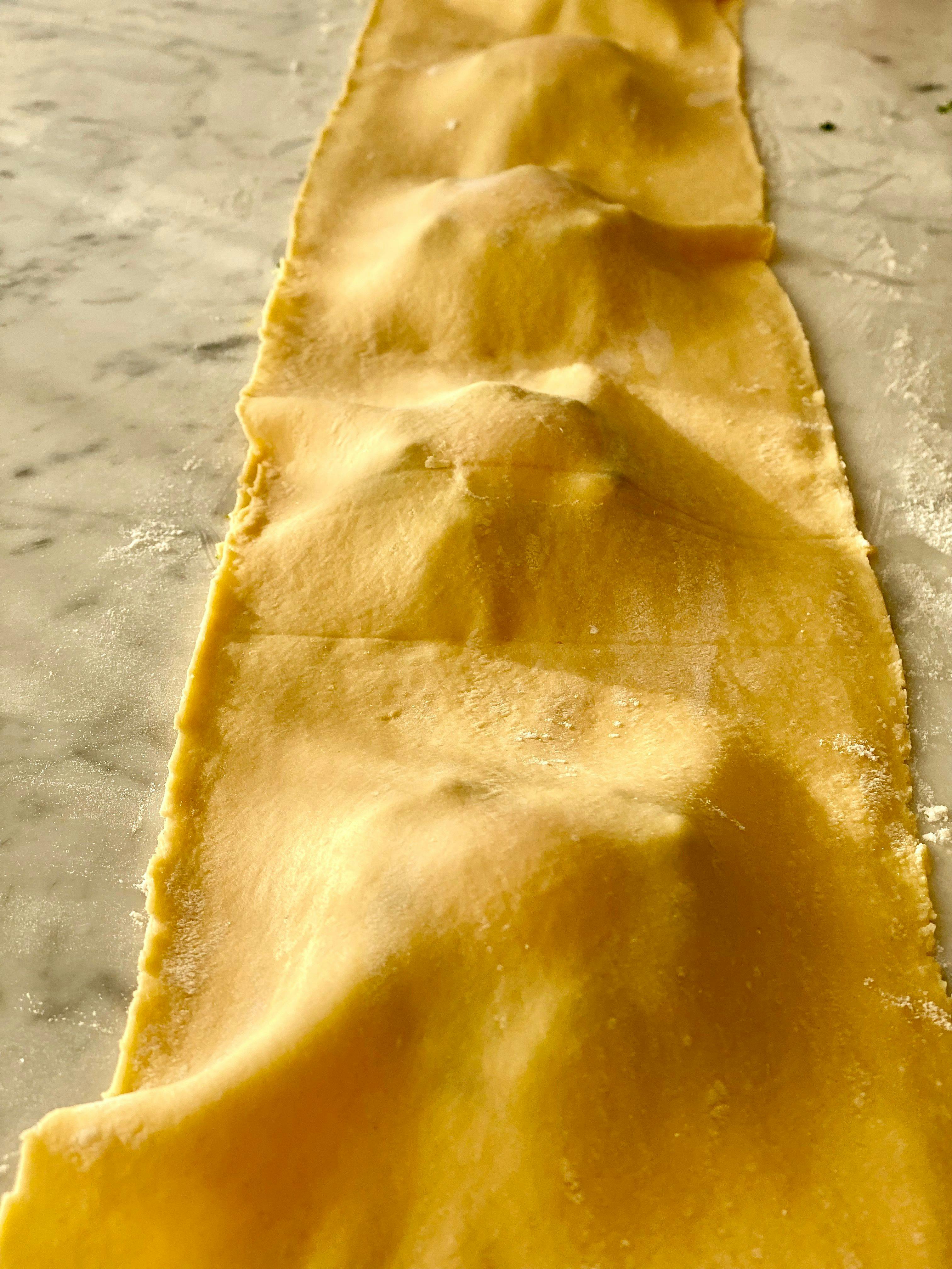 the filling being covered with a sheet of pasta 
