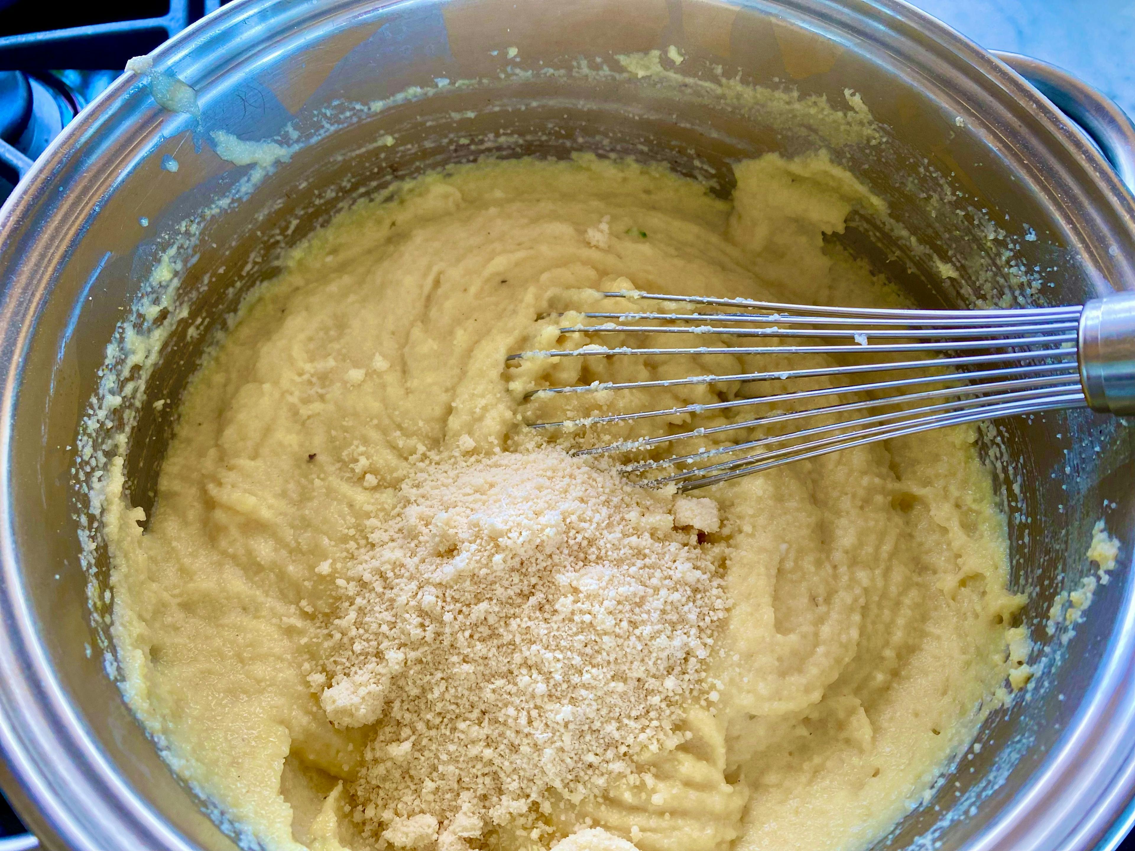 semolina and parmiggiano in saucepan with a whisk