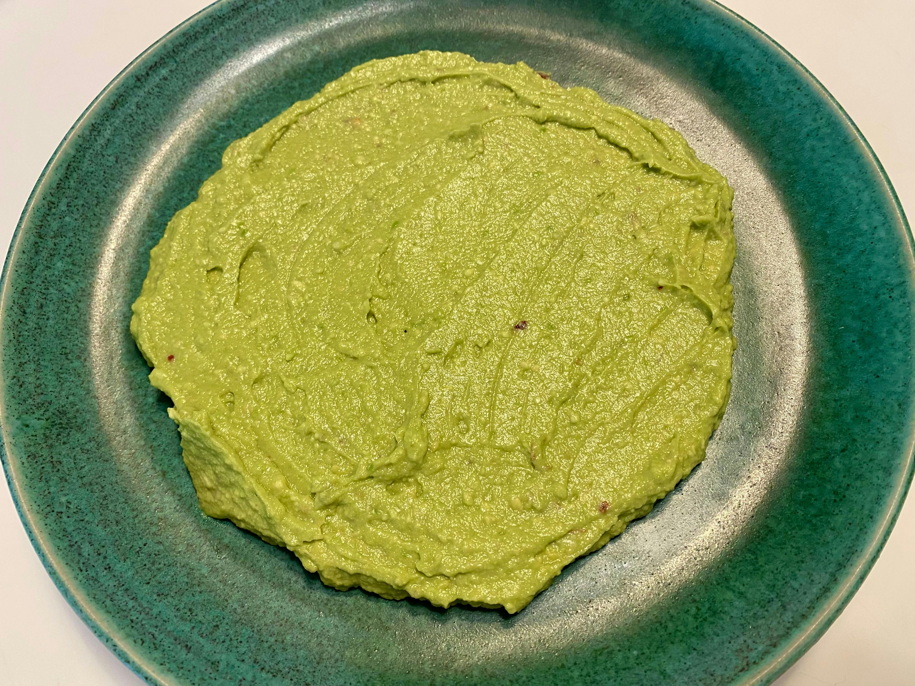 avocado puree spread on a serving plate