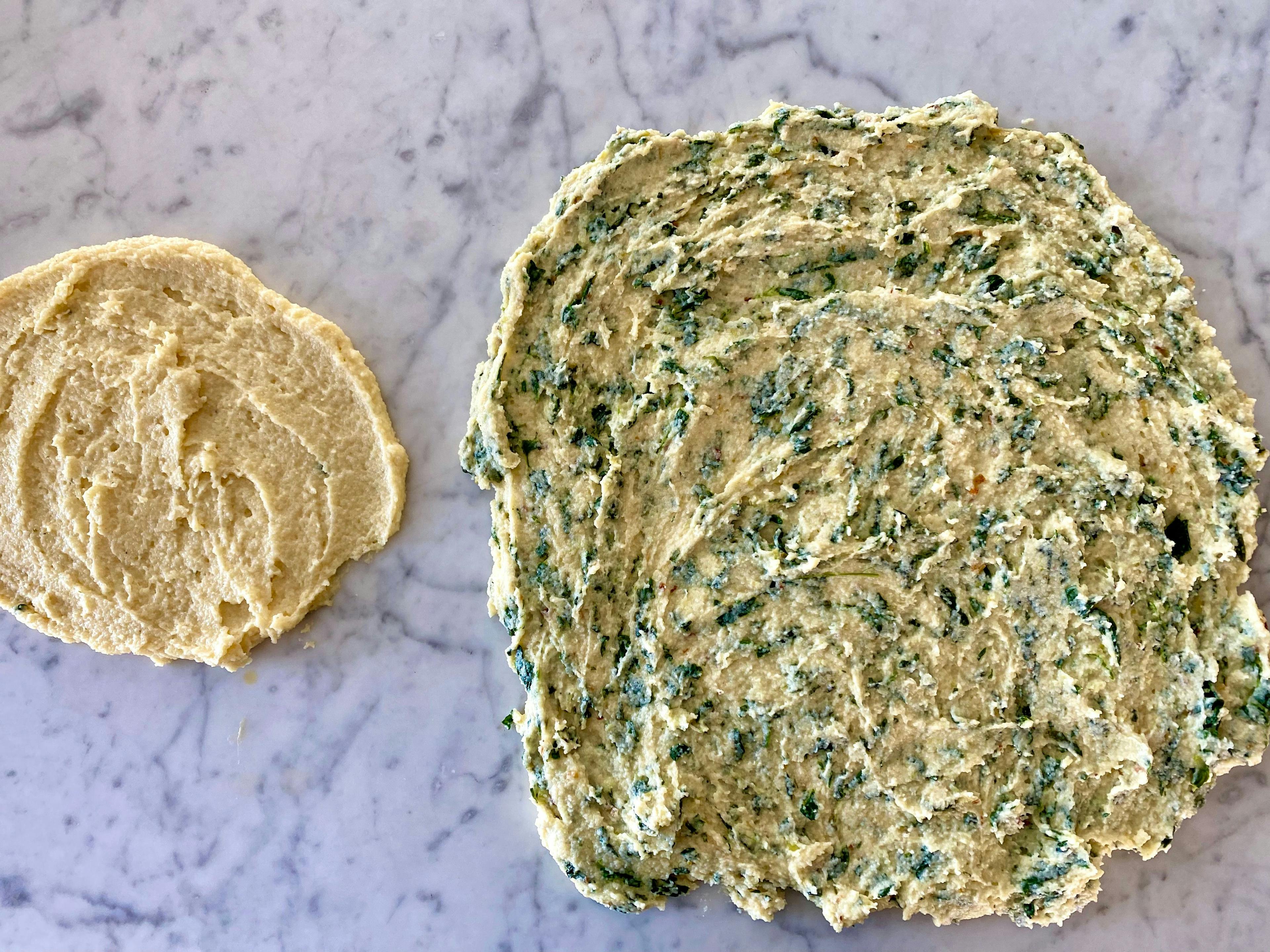 one plain and one spinach semolina flat disc, spread on kitchen bench
