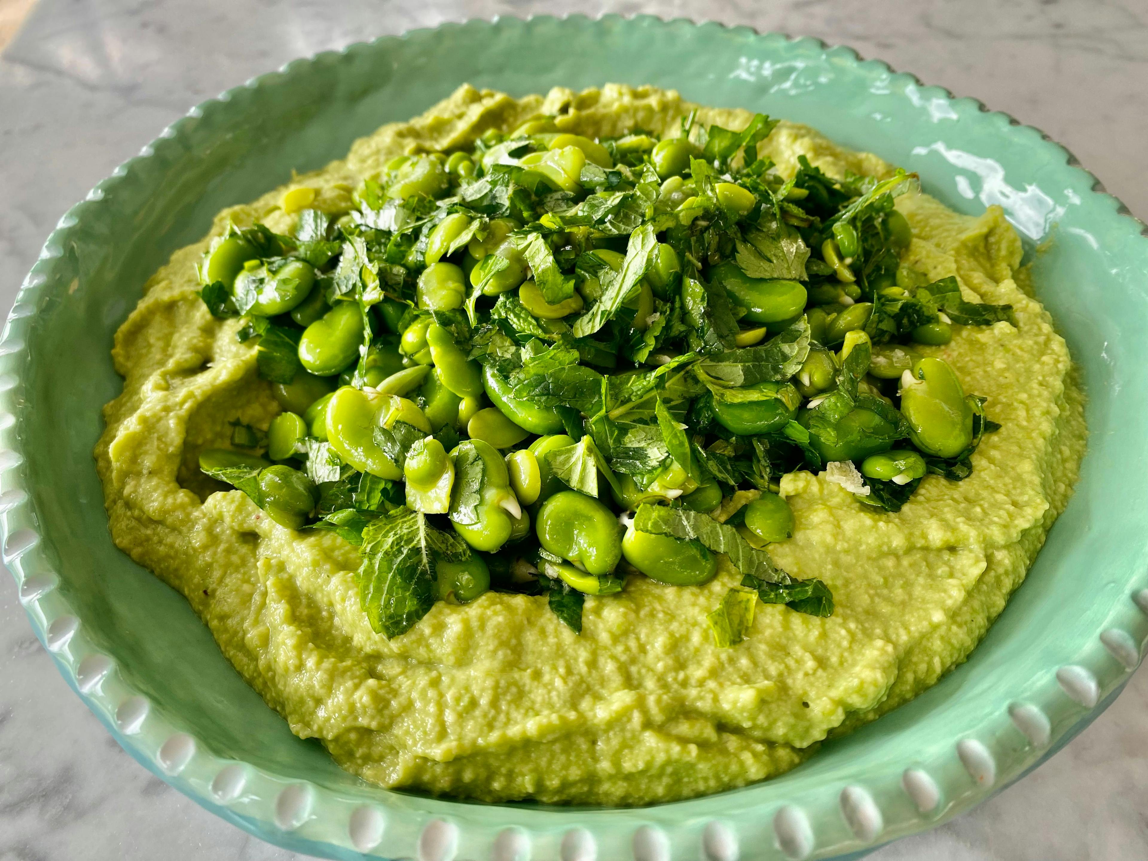 Smashed avocado with shelled broad beans