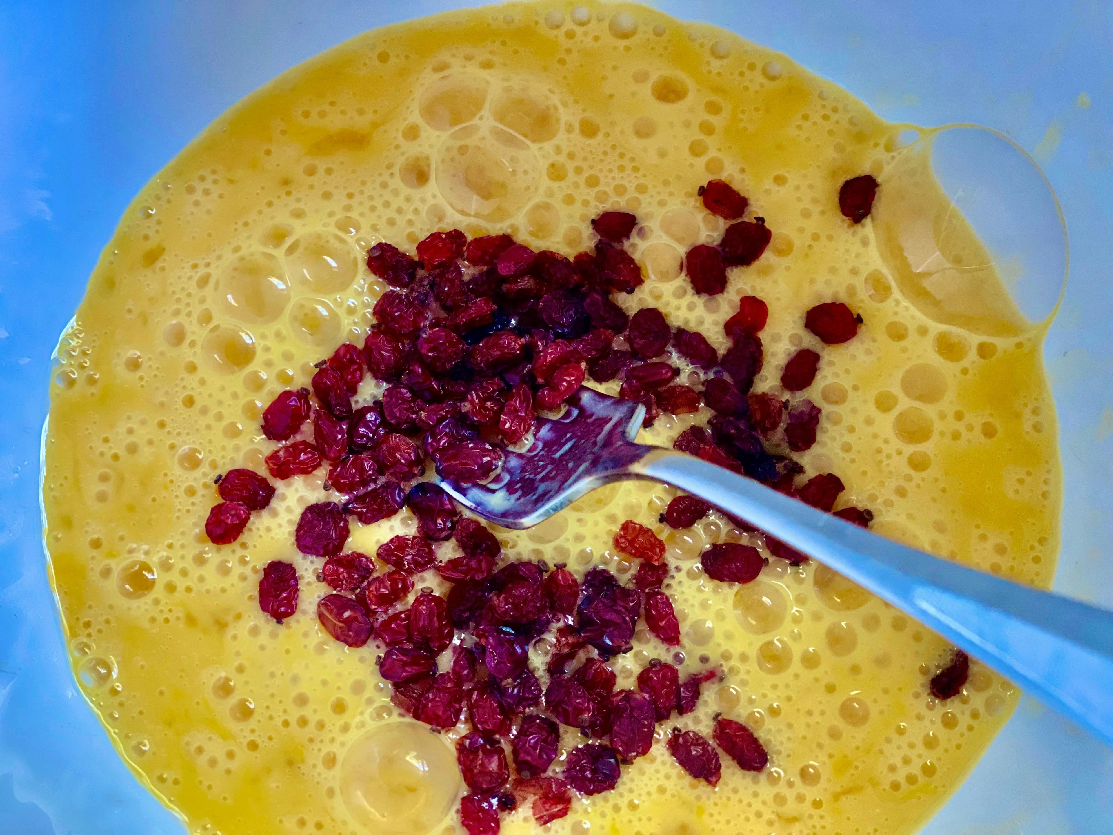 beaten eggs in a bowl with barberries