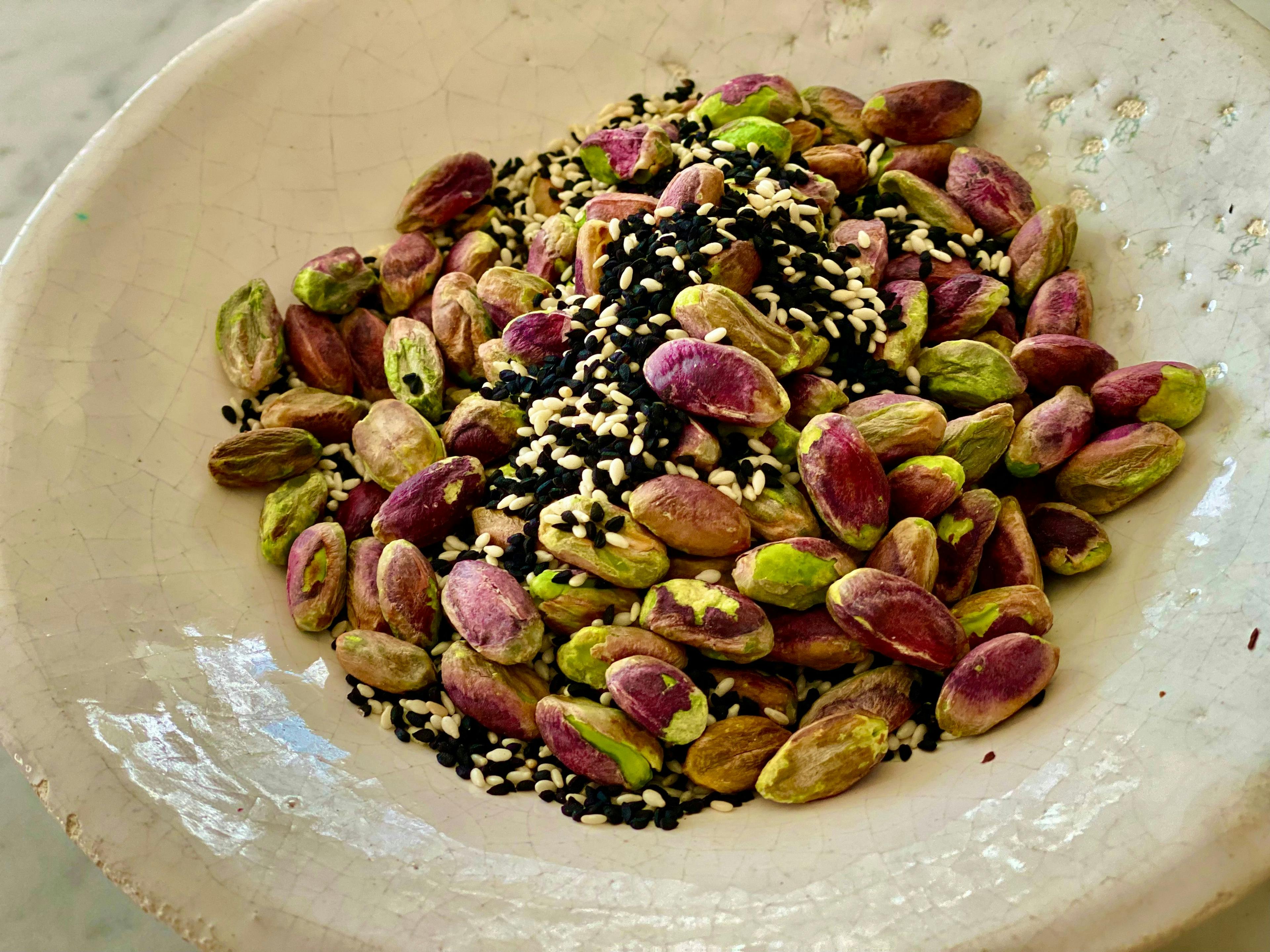 a bowl with pistachio and the seeds